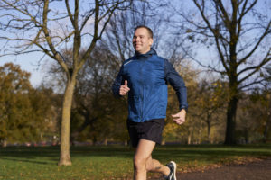 man running and jogging through a park