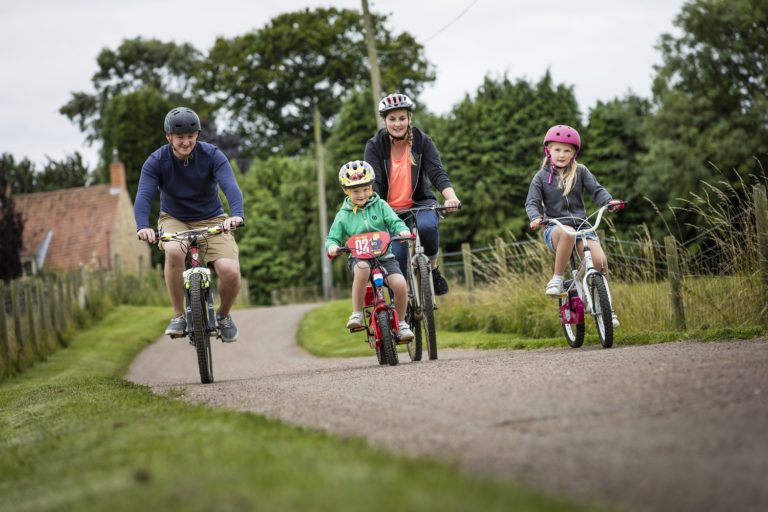 A family cycling along cycle path