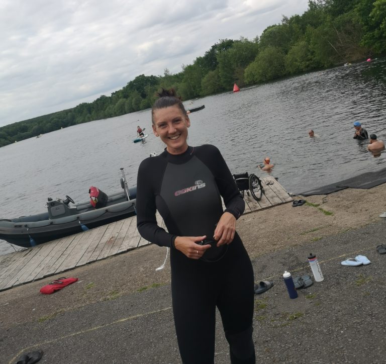 Woman in wetsuit by lake