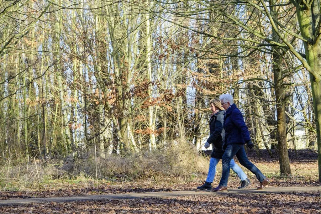 Walking in Boston, Lincolnshire. Two ladies on a woodland walk in winter.