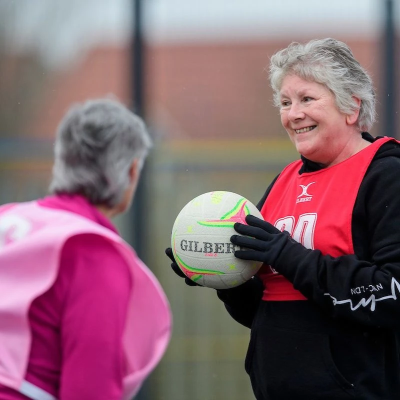 How active should I be? Two older ladies playing walking netball in Lincolnshire.