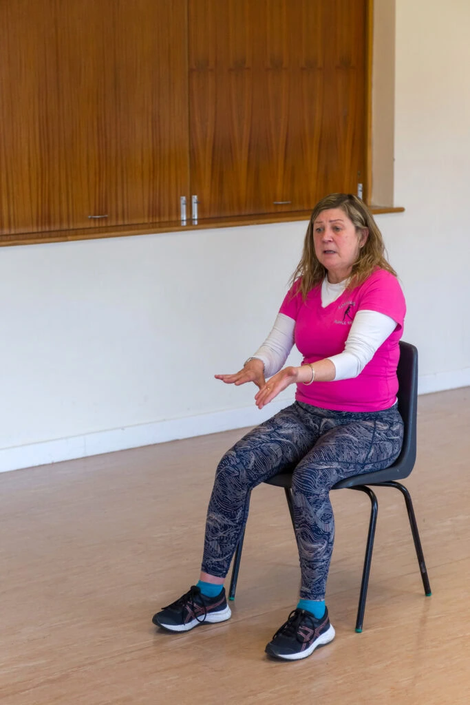 Lorraine showing a seated movement at Lorraine and Her Supple Seniors exercise classes